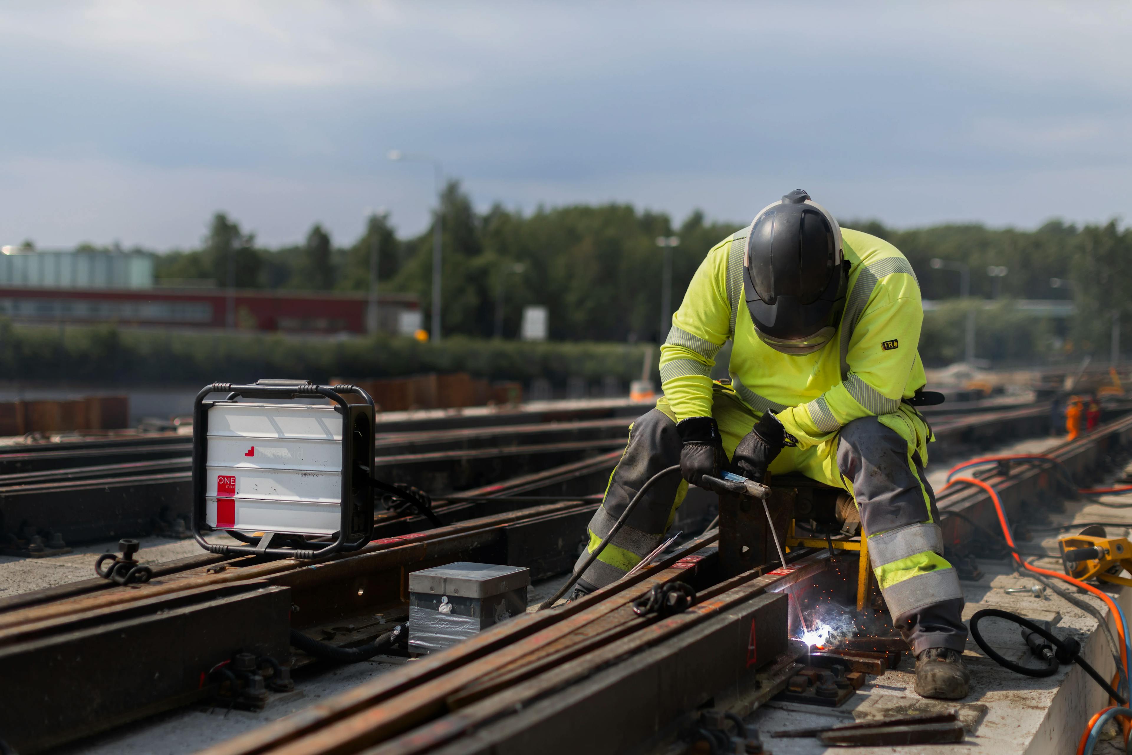 Worker using instagrid for welding railway